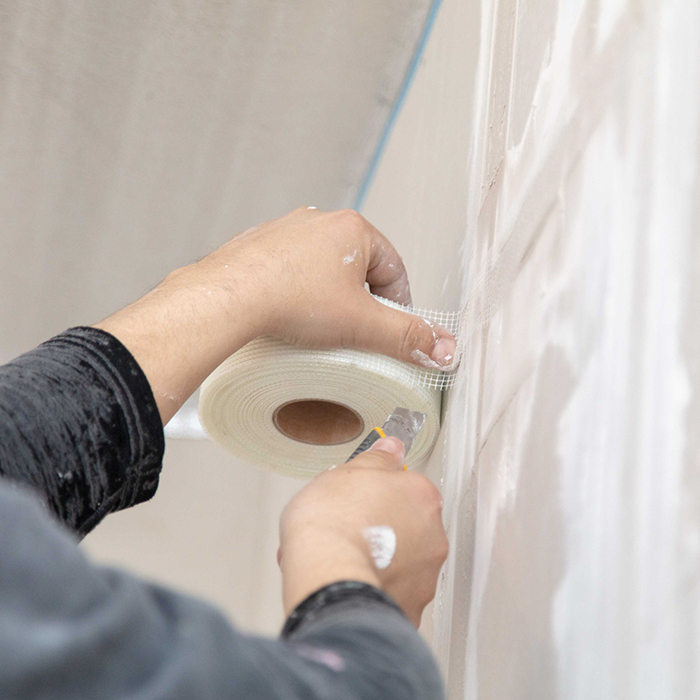 contractor hands close up adding plaster tape at drywall kinnelon nj